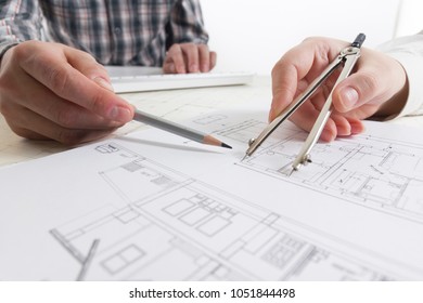 Architects working on blueprint, real estate project. Architect workplace - architectural project, blueprints, ruler, calculator, laptop and divider compass. Construction concept. Engineering tools. - Shutterstock ID 1051844498