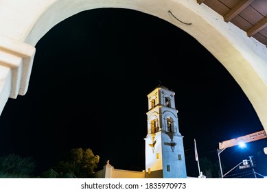 Architectural arch frames the Ojai tower against the night sky twinkling with constellation stars.
