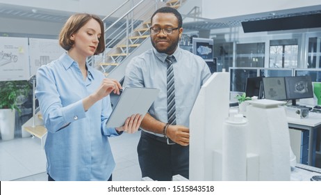 In Architectural Bureau: Architect and Engineer Talking, Working on a Building Complex Prototype Project, Using City Model and Computers Running 3D CAD Software. Residential or Business District - Powered by Shutterstock - Get 15% off with code: PIKWIZARD15
