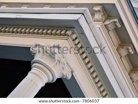 Architectural column and carved detail under the eaves.