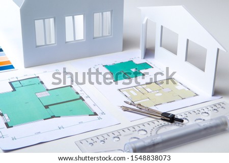 Architectural company. Architect. Office of the architectural bureau. Small copy of the house. Drawings on the architect's desk. Architectural decisions. Work with floor plans. Matching.