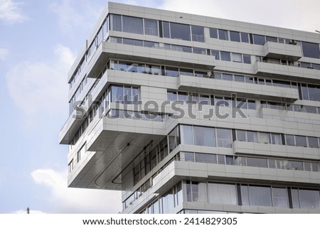 Architectural detail of contemporary modern high rise office building in financial district in Utrecht with reflecting exterior facades