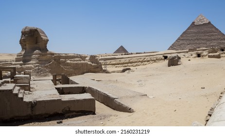 Architectural detail of the Giza pyramid complex with the Great Sphinx of Giza in the foreground and, in the background, the Pyramid of Chephren (right) and the pyramid of Menkaure (left)