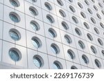 Architectural detail of Jardine House formerly known as Connaught Centre office tower in Hong Kong against Blue skies