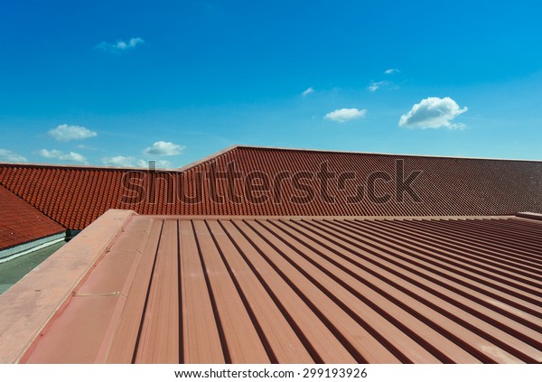 Architectural detail of metal roofing on
commercial construction with blue sky
background