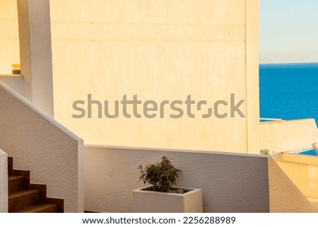 Architectural detail of white mediterranean house by the sea in sunny day. Minimal architecture building detail in Spanish coastline by Mediterranean sea in Spain