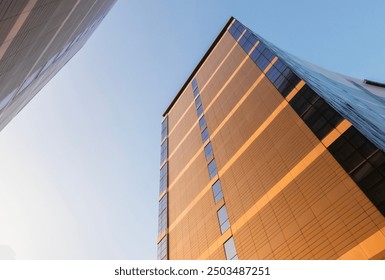 Architectural details of exterior design of skyscraper building in urban area with blue sky background. Abstract pattern of building, lines and curves. - Powered by Shutterstock