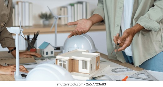 Architectural Discussion. Professionals explaining design concepts with a model in a collaborative setting. - Powered by Shutterstock - Get 15% off with code: PIKWIZARD15