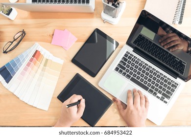 Architectural drawing with work tools, Graphic designer working with digital Drawing tablet and Pen on a computer and color swatches on a desk, interactive pen display, sketching at blank notepad.