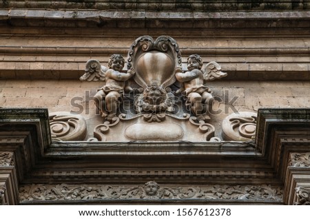 Architectural elements antique decor statues of angels on the stone wall in the ancient italian city