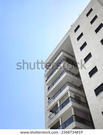 Architectural elements of modern light residential building against vivid blue sky 