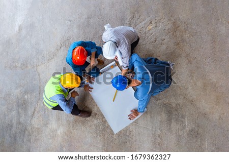 Architectural engineer working on his blueprints with documents on construction site. meeting, discussing,designing, planing