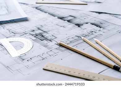 Architectural engineering design plan drawing on the table. Architect's work on table in studio. Construction design and plan - Powered by Shutterstock