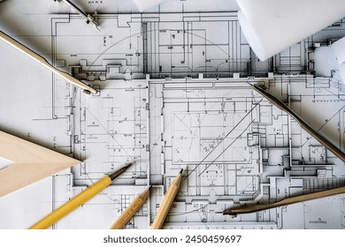 Architectural engineering design plan drawing on the table. Architect's work on table in studio. Construction design and plan - Powered by Shutterstock