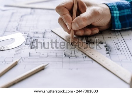 Architectural engineering design plan drawing on the table. Architect's work on table in studio. Construction design and plan