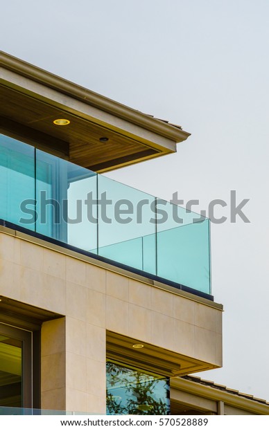 Architectural fragment:  side of the modern\
house with the balcony.\
Vertical.