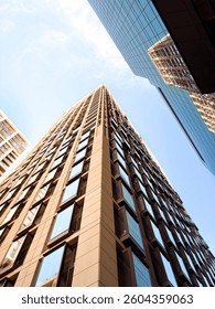 Architectural Marvel: Dramatic Perspective of High-Rise Buildings with Reflective Facades Against Clear Sky in London, UK