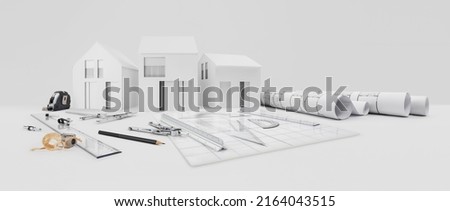 architectural model of houses on desk with drawing technical tools and blueprint rolls, isolated on white background, for building construction plan, interior designer and architect work concept
