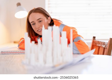 Architectural model review by a young female architect in an office during daylight hours - Powered by Shutterstock