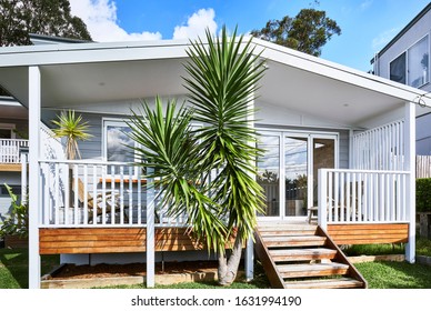 Architectural Photography Of A Coastal Style Granny Flat Bungalow At The Right Of A Suburban Family Home