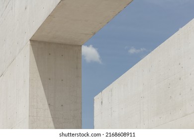 Architectural photography. Geometric composition with two large and strong cement blocks. building against the blue sky with white clouds. Modern structures architecture. Minimalist design fragments.