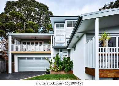 Architectural Photography Of A Grey Coastal Style Home Facade With A Granny Flat Bungalow Off To The Side