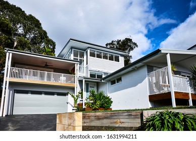 Architectural Photography Of A Grey Coastal Style Home Facade With A Granny Flat Bungalow Off To The Side