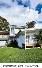 Architectural Photography Of A Grey Coastal Style Home Facade With A Granny Flat Bungalow Off To The Side