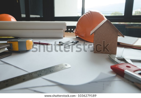 Architectural plans work apace top view.\
Architectural project, blueprints,pencil and divider compass on\
wooden desk table.Construction background.Engineering tools. Copy\
space.Architectural\
Concept