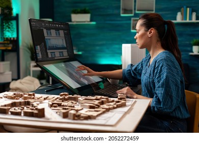 Architectural sketch designer making digital building plan for professional construction renovation. Architect woman using touchpad device computer for property plan virtual project