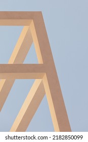 architectural structure image made in concrete bars or beams in light tones, Peach. Yellow cement strips against a blue sky.  abstract background of geometric shapes. minimalist concept. empty space. 