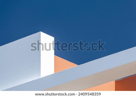 Architecture background abstract geometric shapes. White and orange walls against a blue sky. Modern concrete structure building detail. Architectural construction. Minimal design style. angular lines