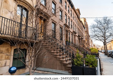 Architecture of brownstone house. Brownstone building architecture of New York. Entrance stairs to brick brownstone building. Architectural exterior. New York city architecture. Residential building