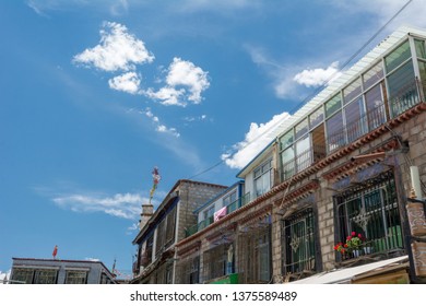 Architecture Of Buildings In Pargor Subdistrict Located In Lhasa, Tibet. Background With Sunny Blue Sky And Clouds.