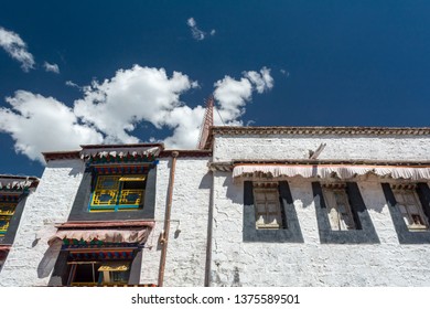 Architecture Of Buildings In Pargor Subdistrict Located In Lhasa, Tibet. Background With Sunny Blue Sky And Clouds.