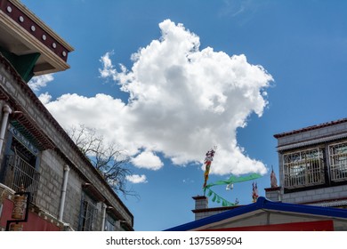 Architecture Of Buildings In Pargor Subdistrict Located In Lhasa, Tibet. Background With Sunny Blue Sky And Clouds.