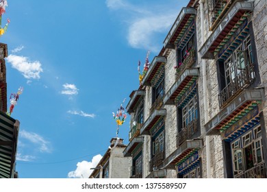 Architecture Of Buildings In Pargor Subdistrict Located In Lhasa, Tibet. Background With Sunny Blue Sky And Clouds.