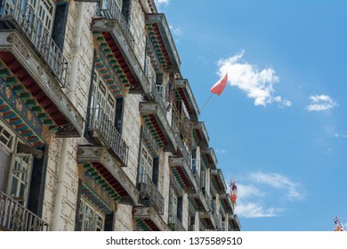 Architecture Of Buildings In Pargor Subdistrict Located In Lhasa, Tibet. Background With Sunny Blue Sky And Clouds.