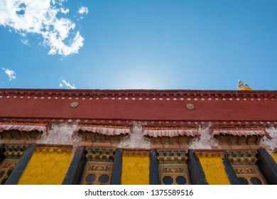 Architecture Of Buildings In Pargor Subdistrict Located In Lhasa, Tibet. Background With Sunny Blue Sky And Clouds.