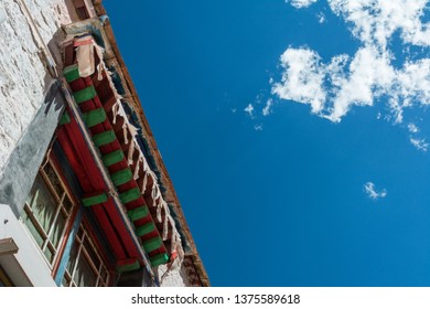 Architecture Of Buildings In Pargor Subdistrict Located In Lhasa, Tibet. Background With Sunny Blue Sky And Clouds.