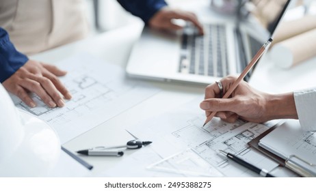 Architecture drawing on architectural project business architecture building construction Colleagues designer Planning Design on blueprint with compasses - Powered by Shutterstock