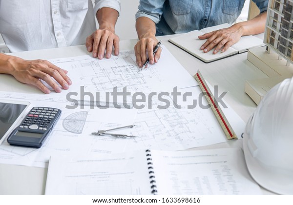 Architecture Engineer Teamwork\
Meeting, Drawing and working for architectural project and\
engineering tools on workplace, concept of work on technical\
drawings.