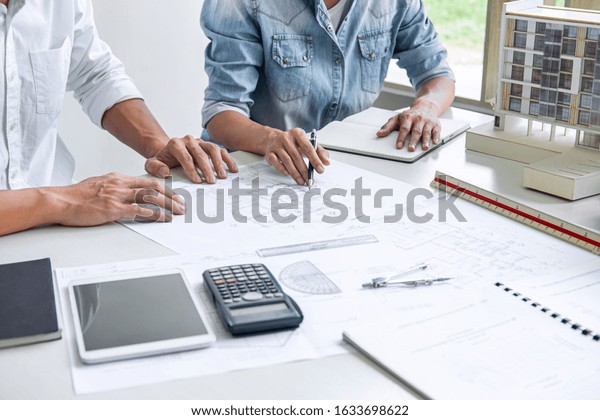 Architecture Engineer Teamwork\
Meeting, Drawing and working for architectural project and\
engineering tools on workplace, concept of work on technical\
drawings.