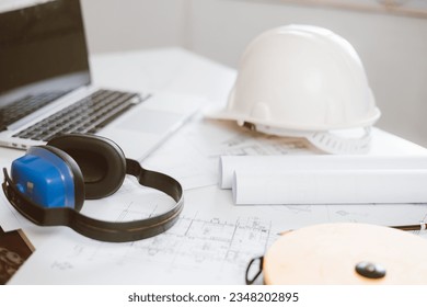 Architecture engineer working and blueprints   laptop in office  Inspection in workplace for architectural plan  Construction project  Adviser construction site engineer 