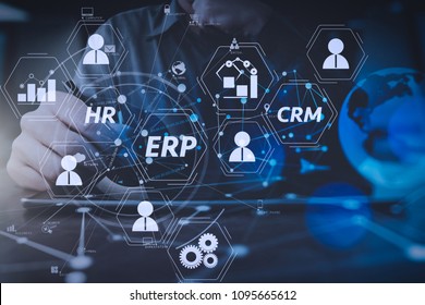 Architecture of ERP (Enterprise Resource Planning) system with connections between business intelligence (BI), production, CRM modules and HR diagram.businessman hand working with modern digital table