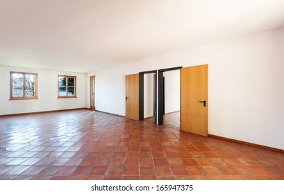 Architecture, interior, empty room with two doors, terracotta floor