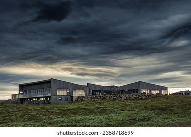 Architecture modern building of the visitor Gullfoss tourist centre with brandname shop, restaurant, souvenir and information service with dramatic sky on gloomy day in summer