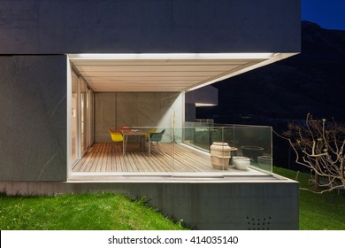 Architecture modern design, concrete house, lit terrace at night