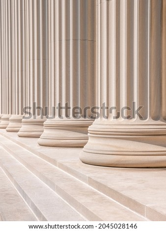 The architecture of a set of neoclassic columns showcasing their perfect shapes and symmetric alignment. 