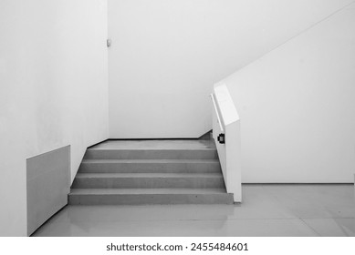 Architecture. White room interior. Empty ambient background. White walls with gray staircase.